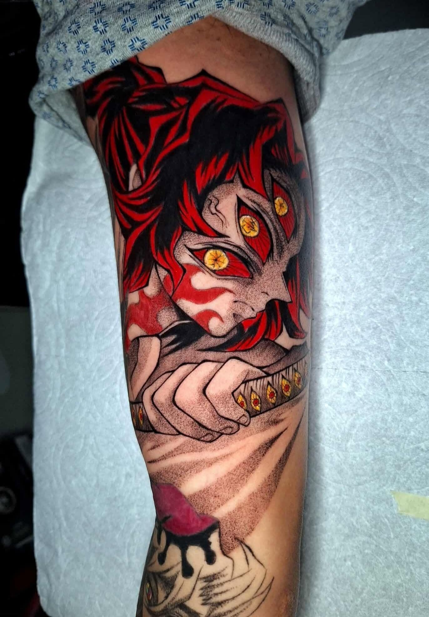 Blackwork tattoo of a blade-wielding figure in a patterned haori