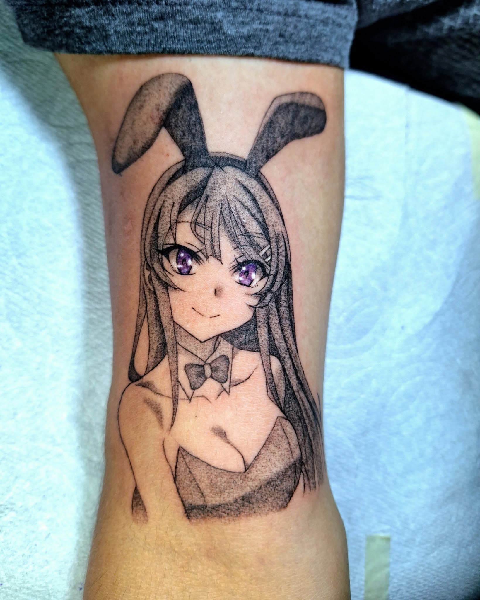 Anime-style tattoo of a female figure with flowing hair